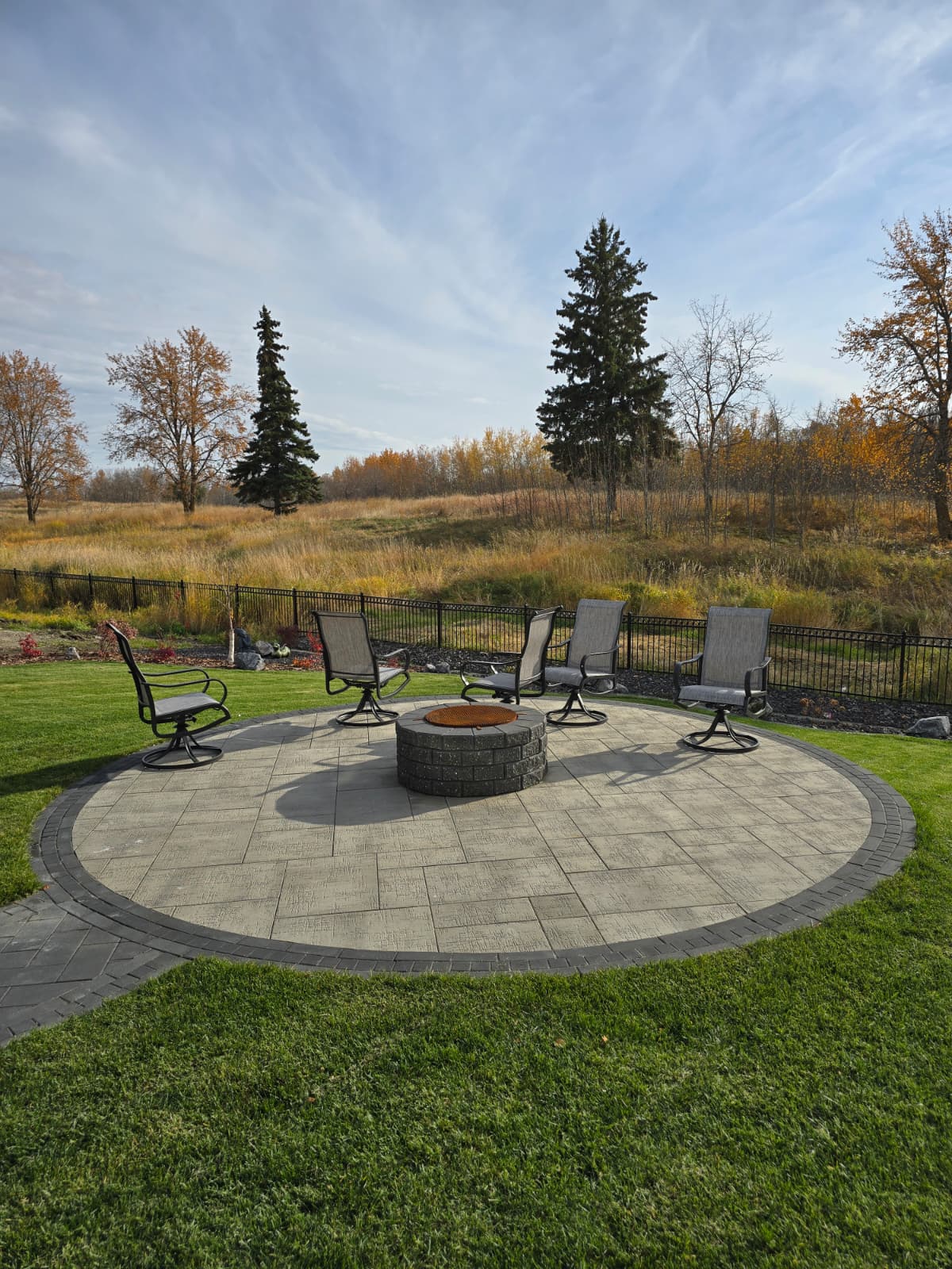 Round stone paver firepit patio — Edmonton