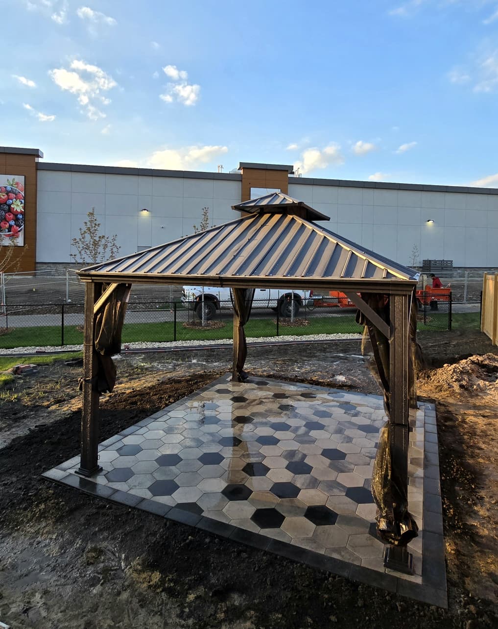 Metal-roof gazebo over hexagonal tile pad — Edmonton