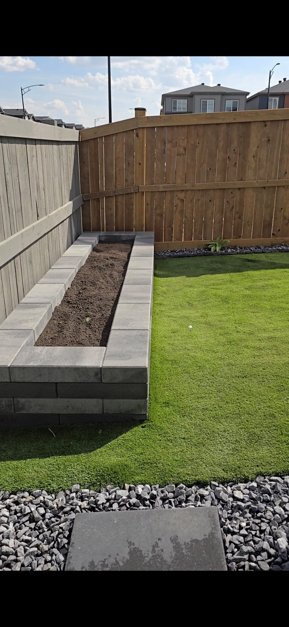Concrete block retaining wall with raised garden bed — Edmonton