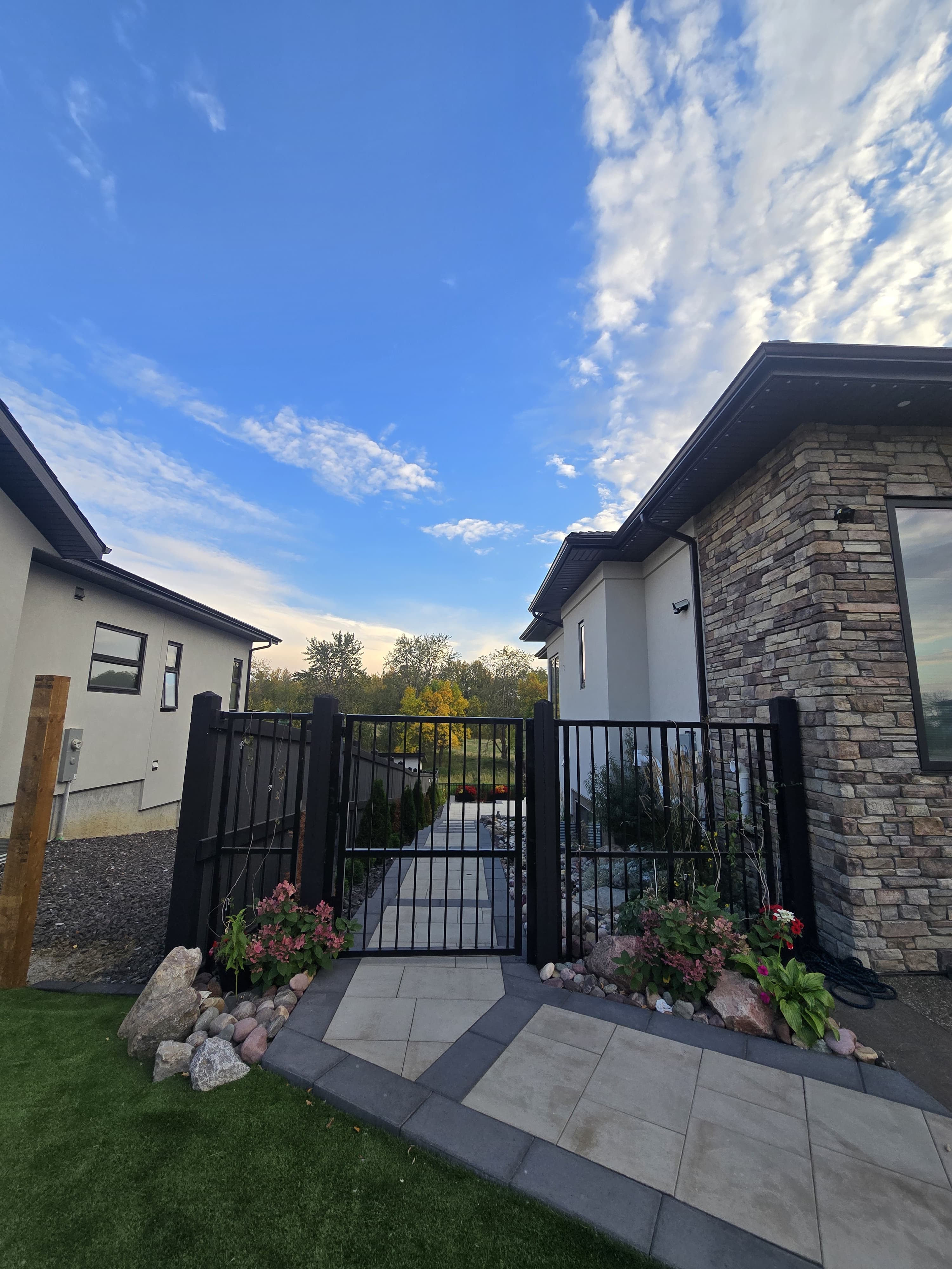Hardscape gate and walkway at dusk — Edmonton