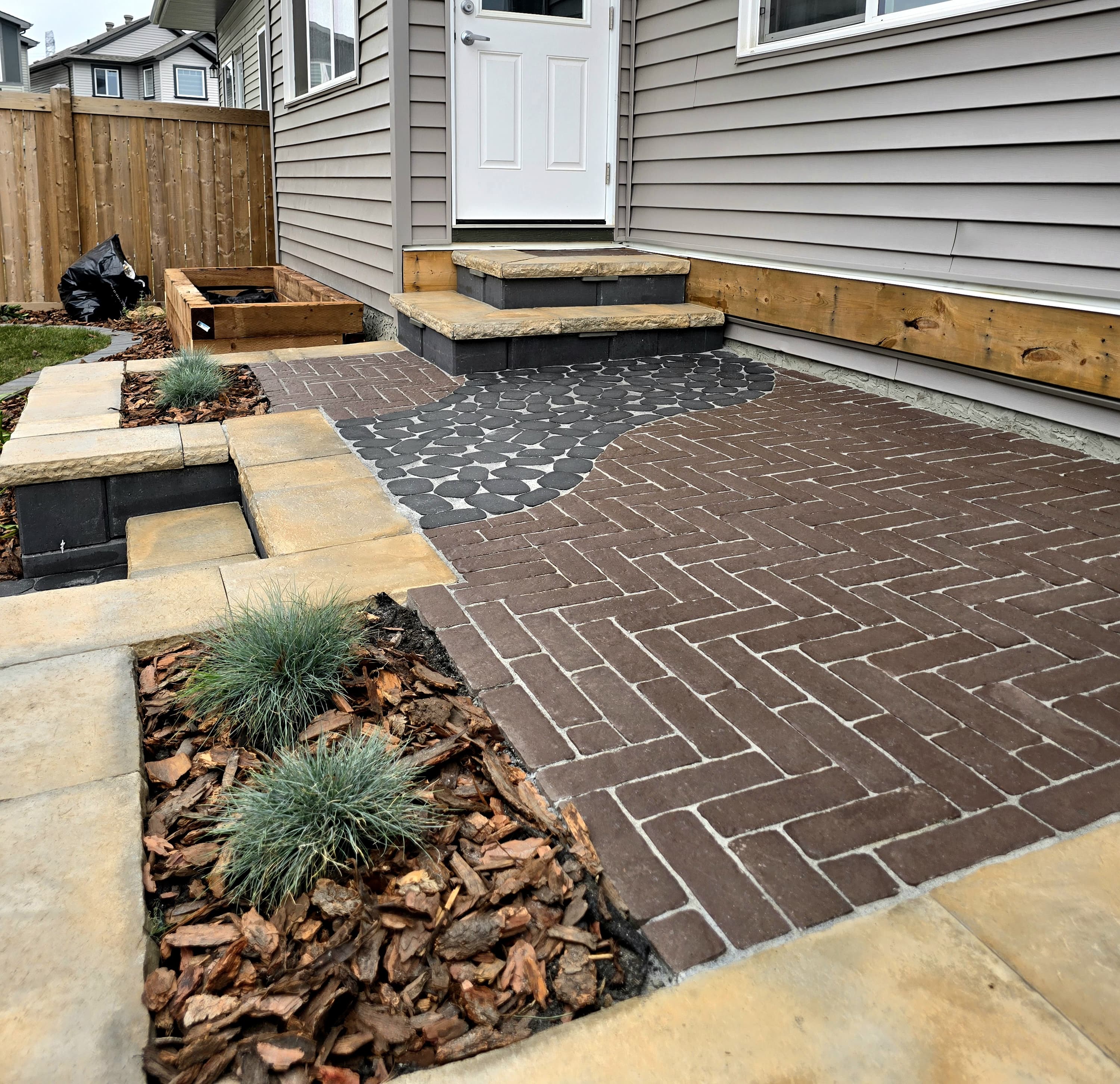 Herringbone paver patio at a backyard entry — Edmonton