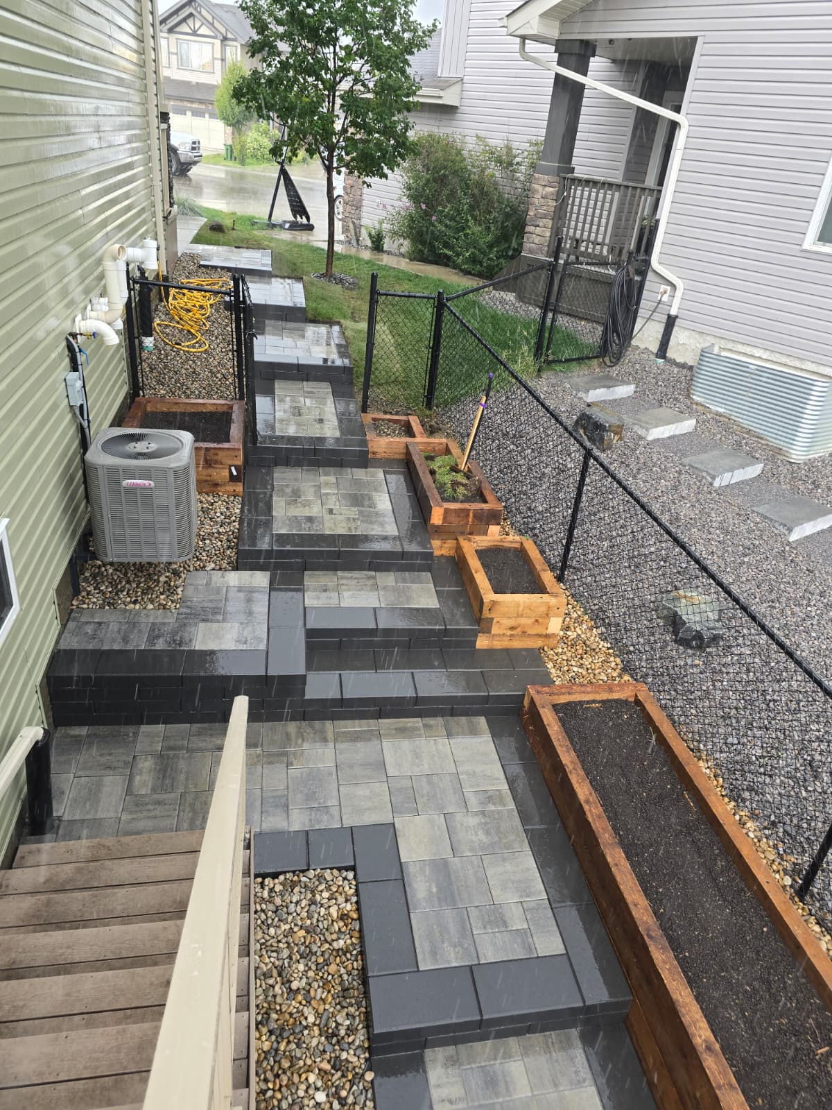 Paver steps with built-in planters in sideyard — Edmonton