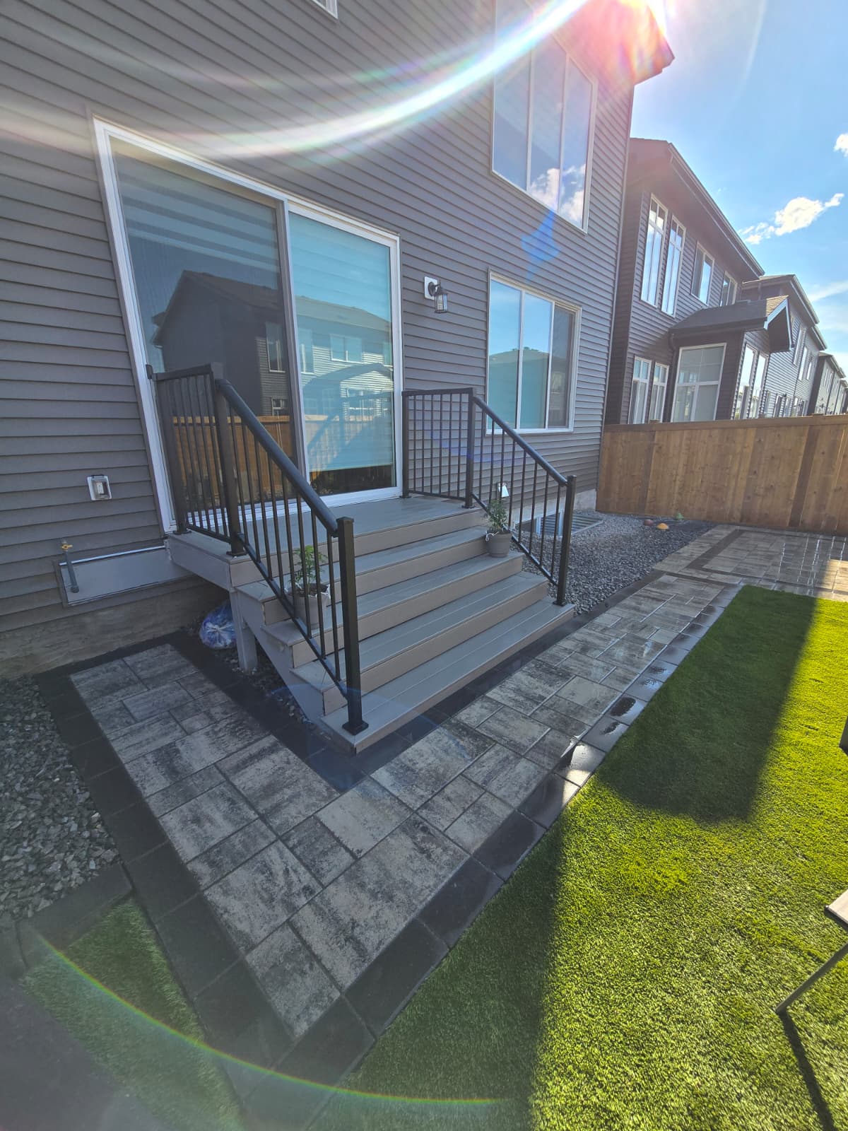 Backyard patio with deck stairs — Edmonton