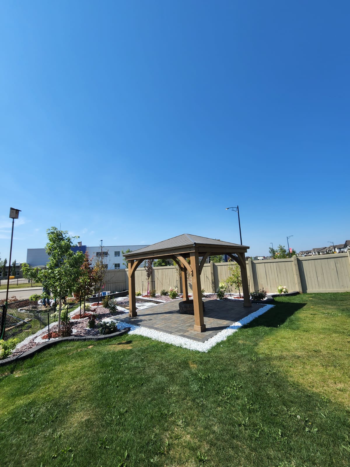 Wood pergola gazebo over paver pad — Edmonton