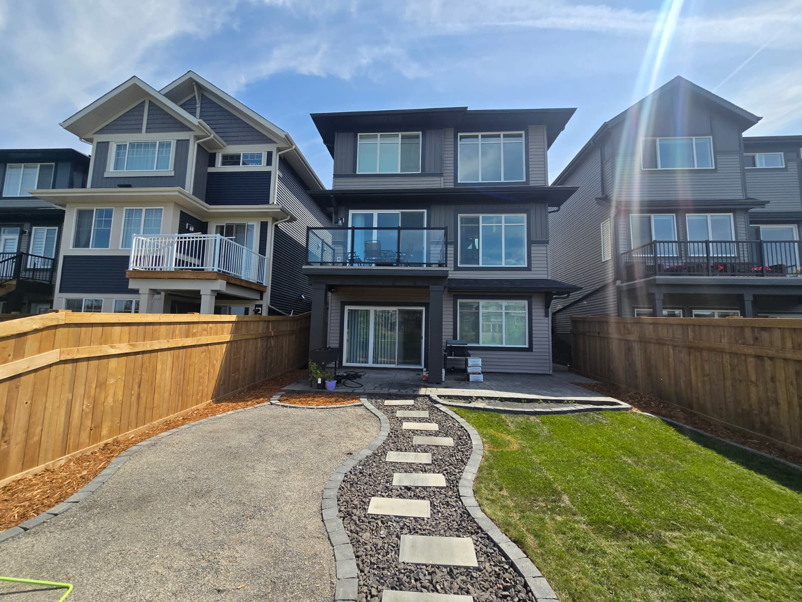 Backyard landscaping with stone steppers — Edmonton