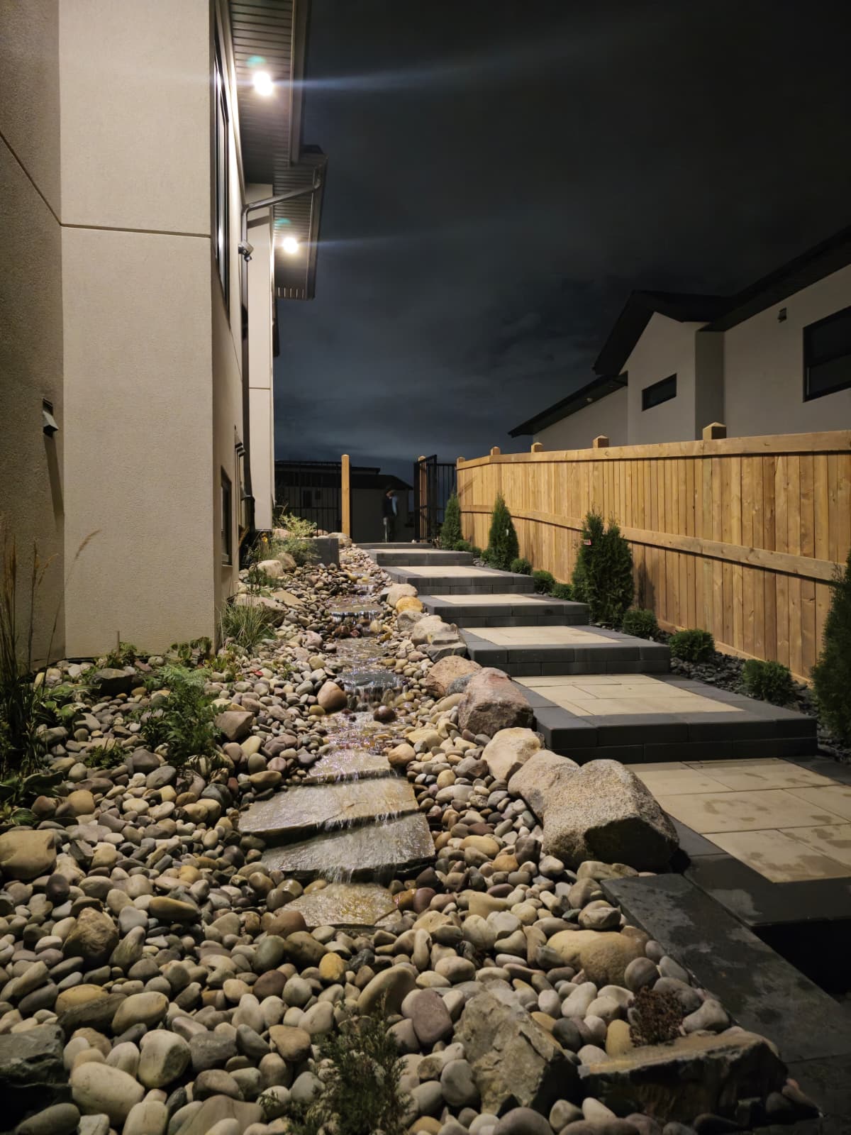 Outdoor staircase with landscape lighting installed at night — Edmonton